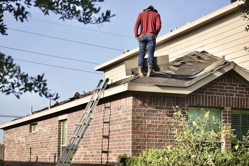 Professional roofer working on a residential roof in Garner